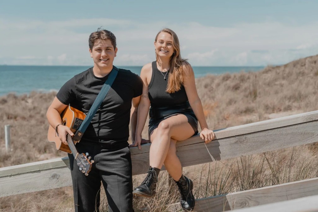 Sammie and Angelo with acoustic guitar at the beach